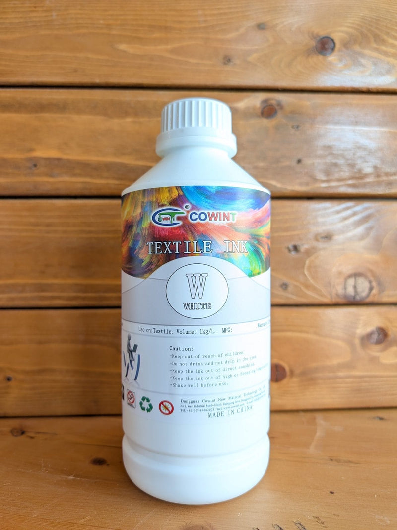 Cowint white DTF ink, 1 liter bottle, on the bench at Armor Ink