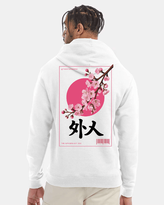 Man in white hoodie with Japanese cherry blossom design.
