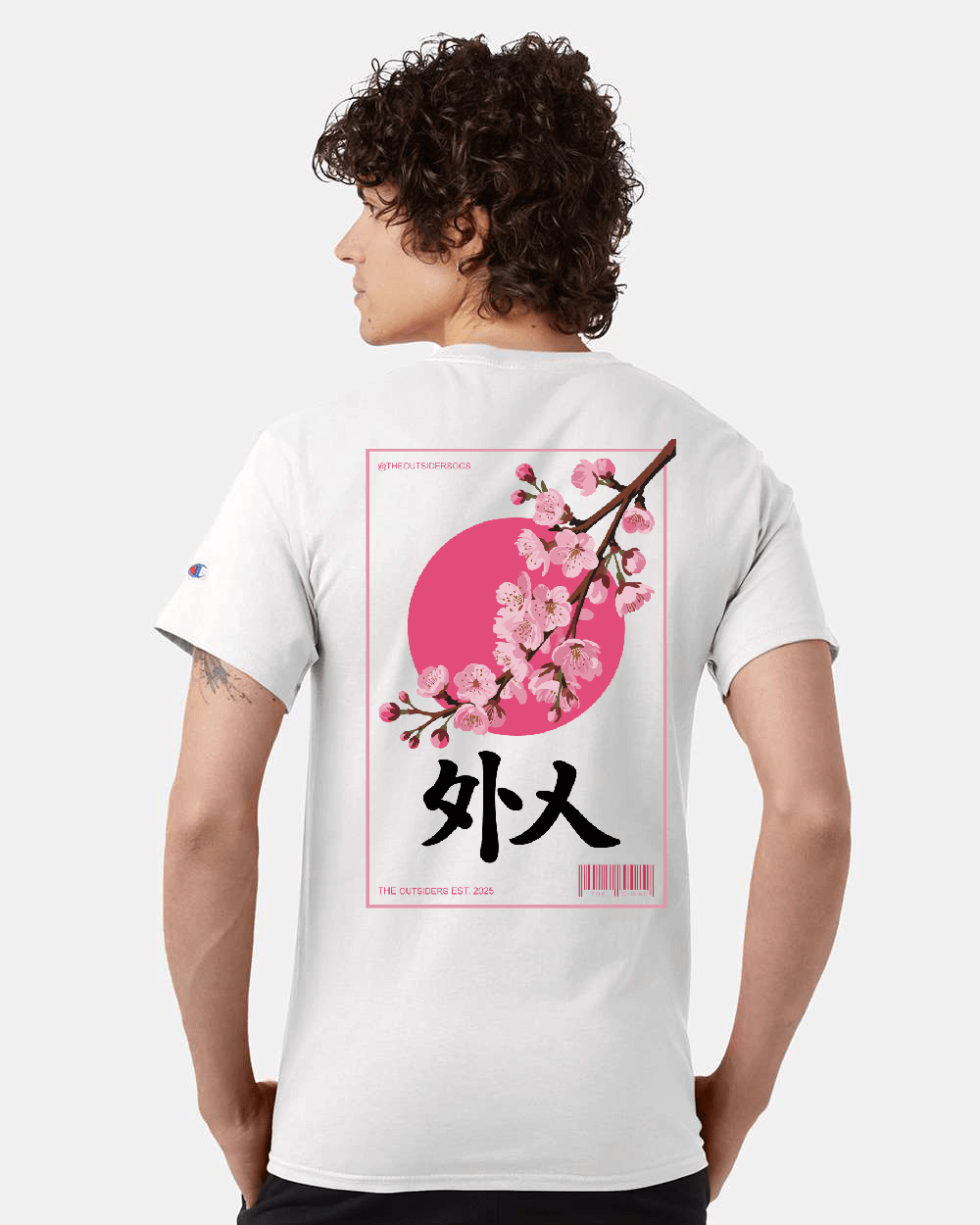 Man wearing white t-shirt with cherry blossom design.