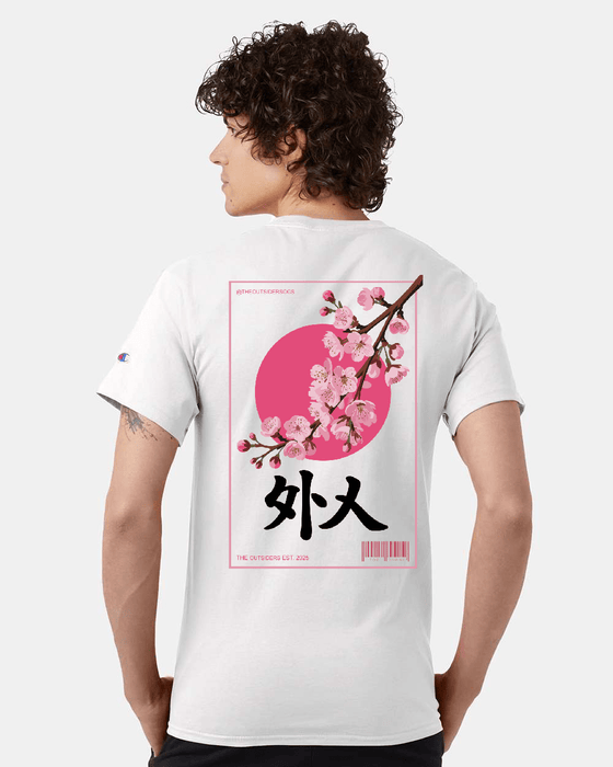 Man wearing white t-shirt with cherry blossom design.